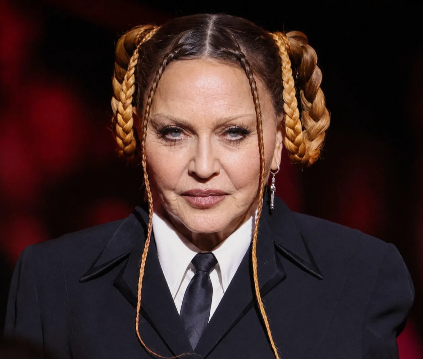 In the AI interpretation, Madonna's distinctive braided hairstyle, tailored outfit and pose remain intact as her facial appearance is reimagined.