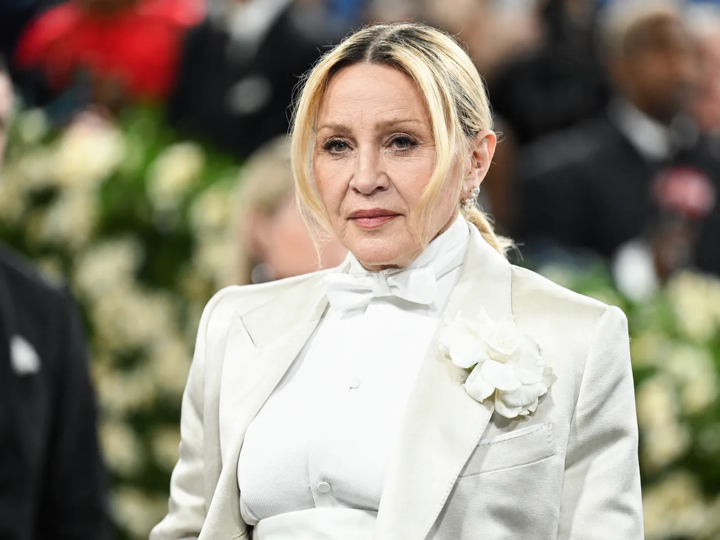 In the AI reimagining, Madonna's formal white look remains intact while her face is shown with more visible signs of aging.