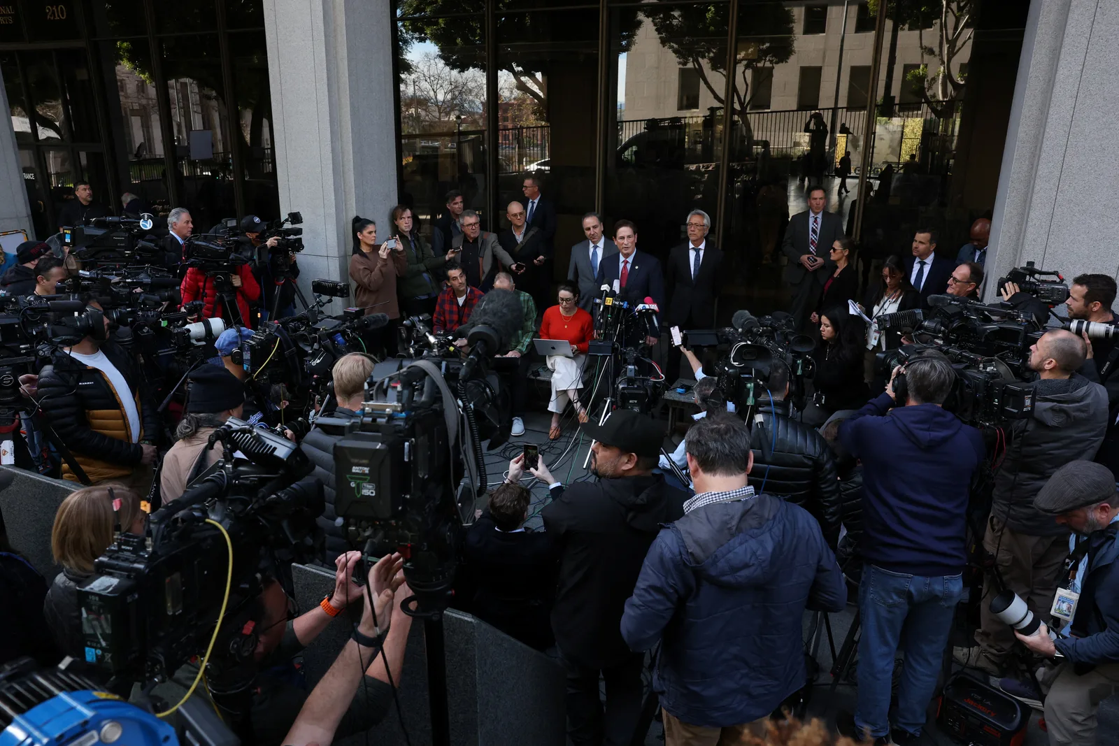 Officials speak to members of the media outside Los Angeles County Superior Court following the arraignment on February 23, 2026