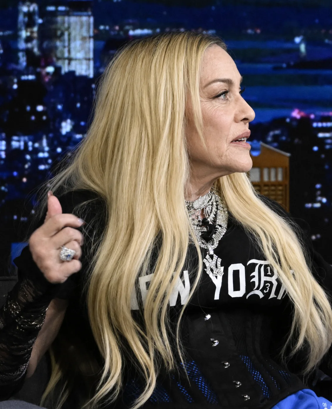 The digitally reworked portrait retains Madonna's long blond hair, jewelry, clothing and seated pose while changing the appearance of her face.