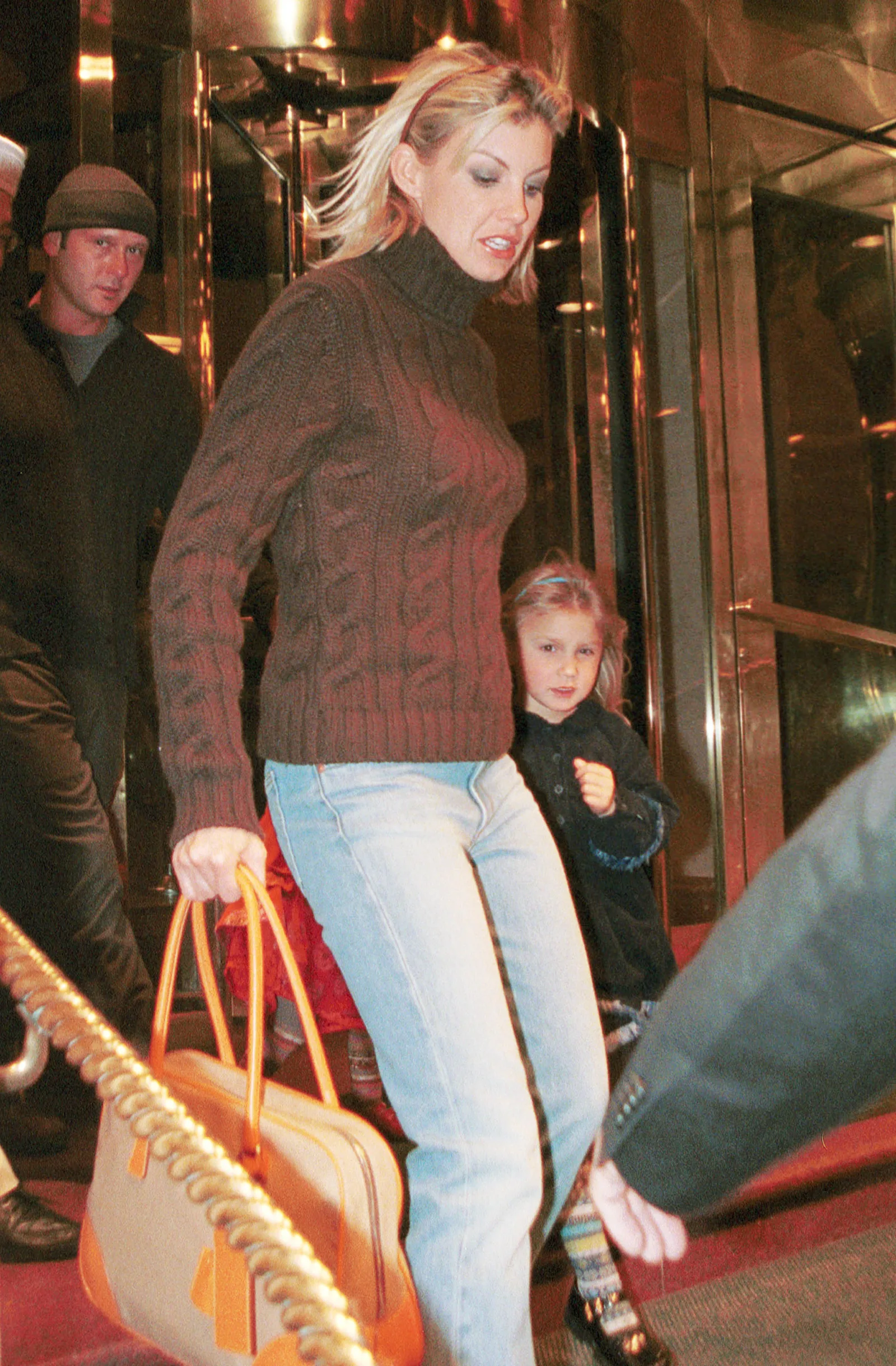Faith Hill steps out with young Gracie McGraw in New York City in March 2001. As the eldest of Tim McGraw and Hill's three daughters, Gracie grew up in the public eye before later becoming an outspoken advocate for body positivity and self-acceptance.