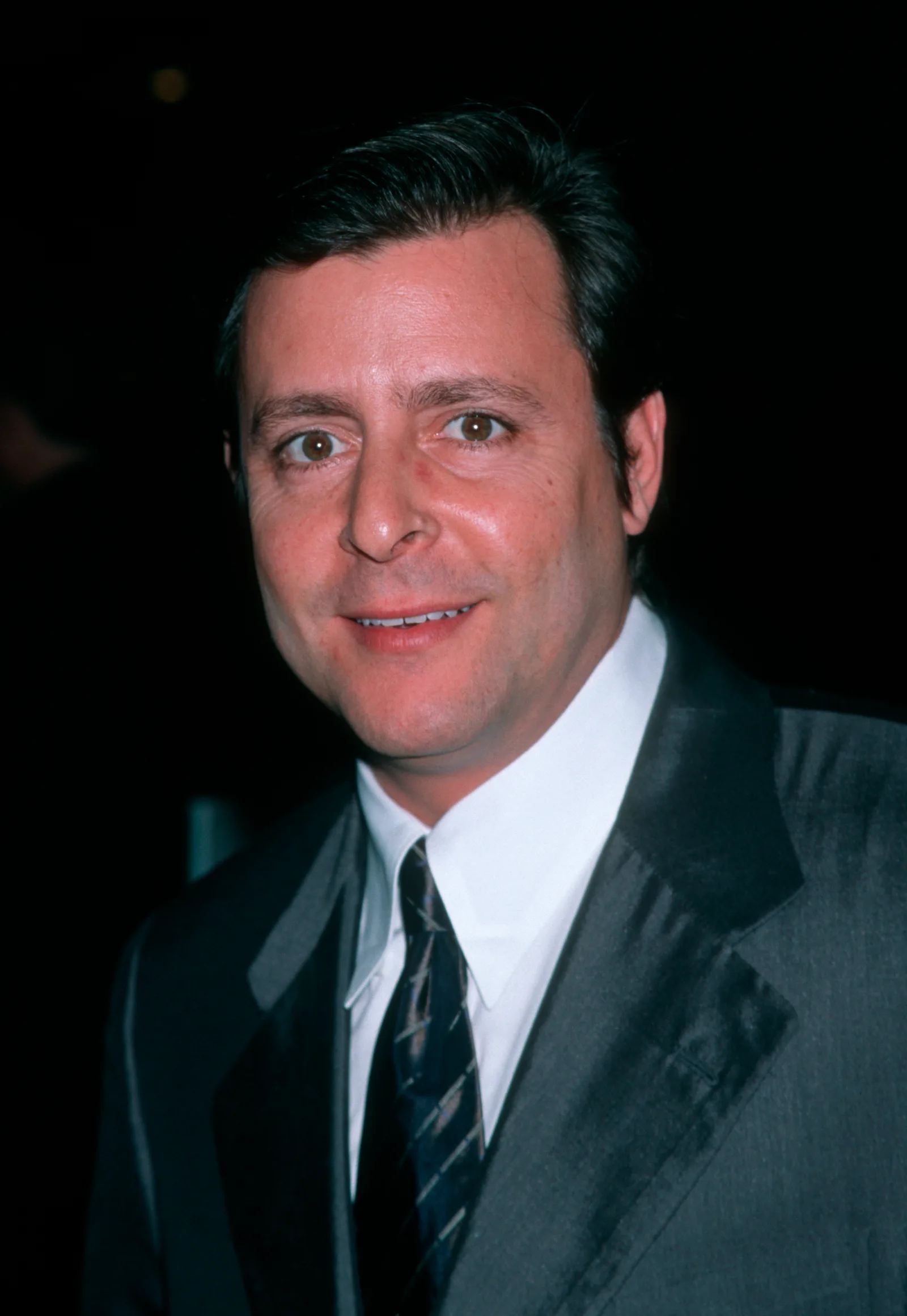 Dressed in a sleek dark suit and crisp white shirt, the performer offered a warm smile while attending the Skirball Cultural Center Awards at the Shrine Auditorium.