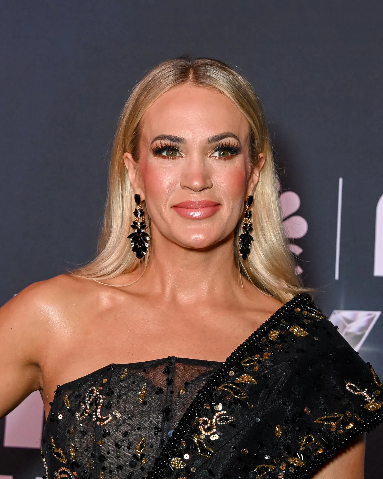 Carrie Underwood attended NBC's "Opry 100: A Live Celebration" at the Grand Ole Opry House in Nashville in March 2025. The red carpet appearance showcased her signature blonde hair and glamorous styling during another busy year in the spotlight.