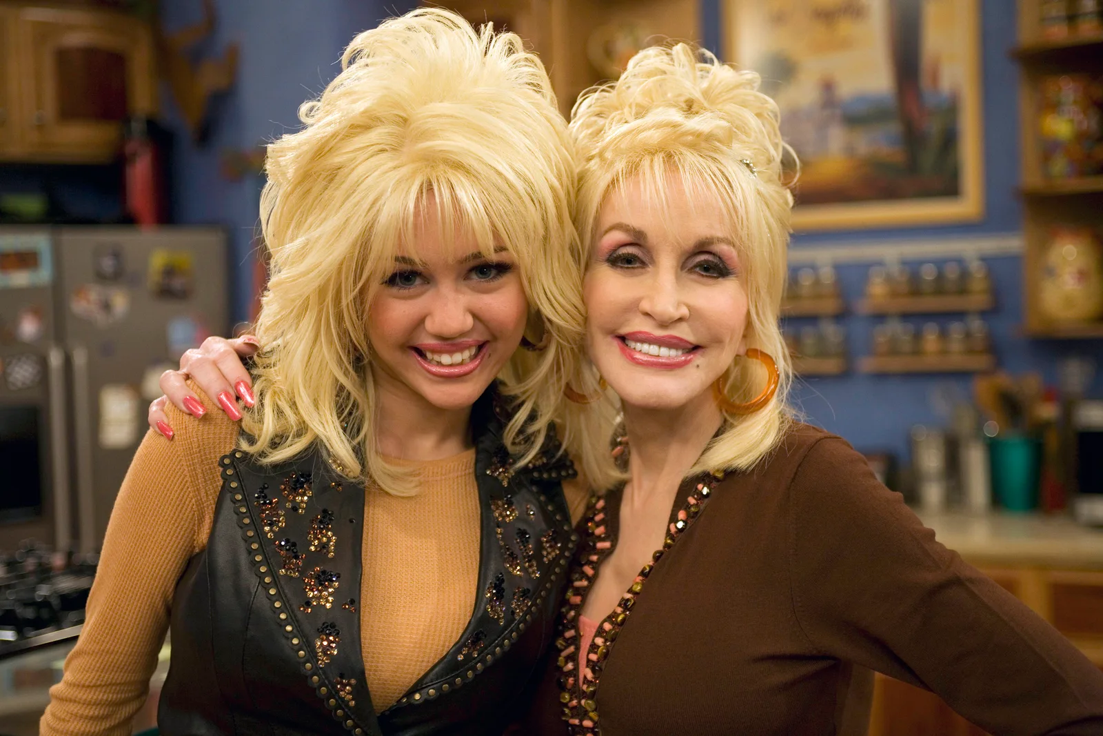 Miley Cyrus and Dolly Parton pose together in 2007, capturing the close bond between the singer and her famous godmother years before Parton's death.