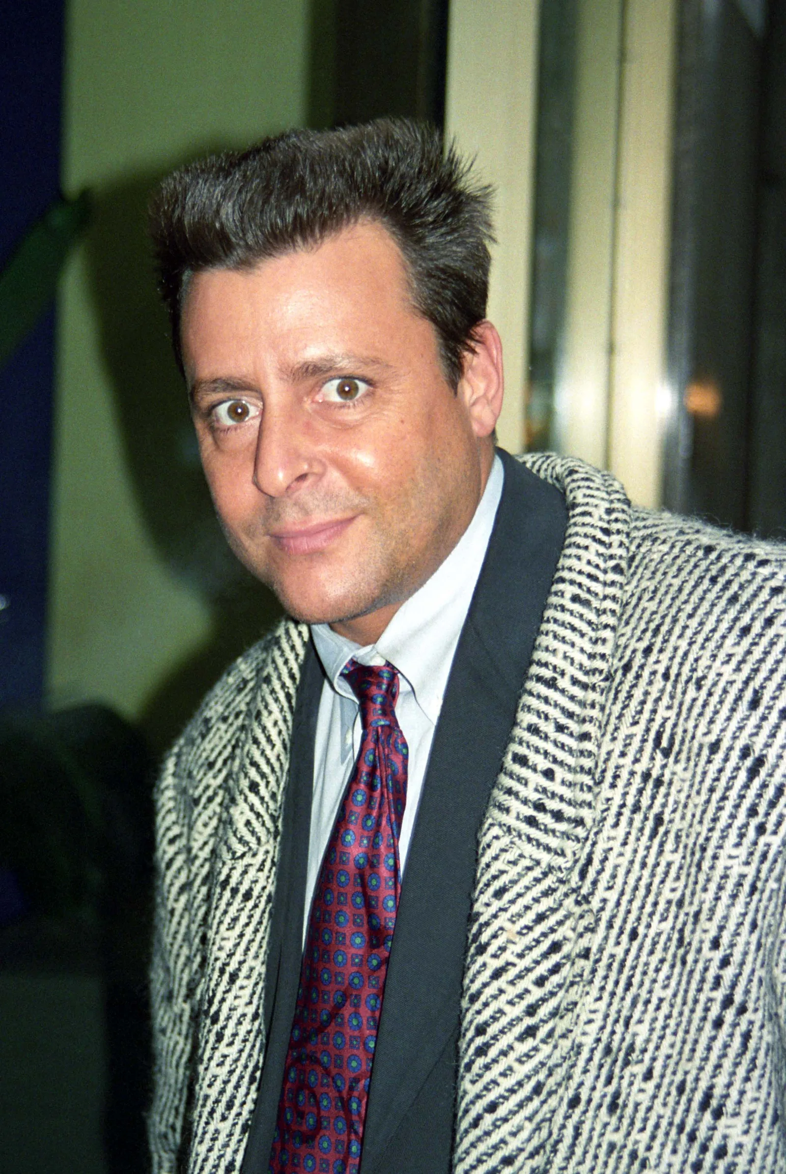 Sporting a patterned tweed coat, a red patterned tie, and a styled haircut, the actor made an appearance on "Fox After Breakfast" in New York City on February 11, 1997.