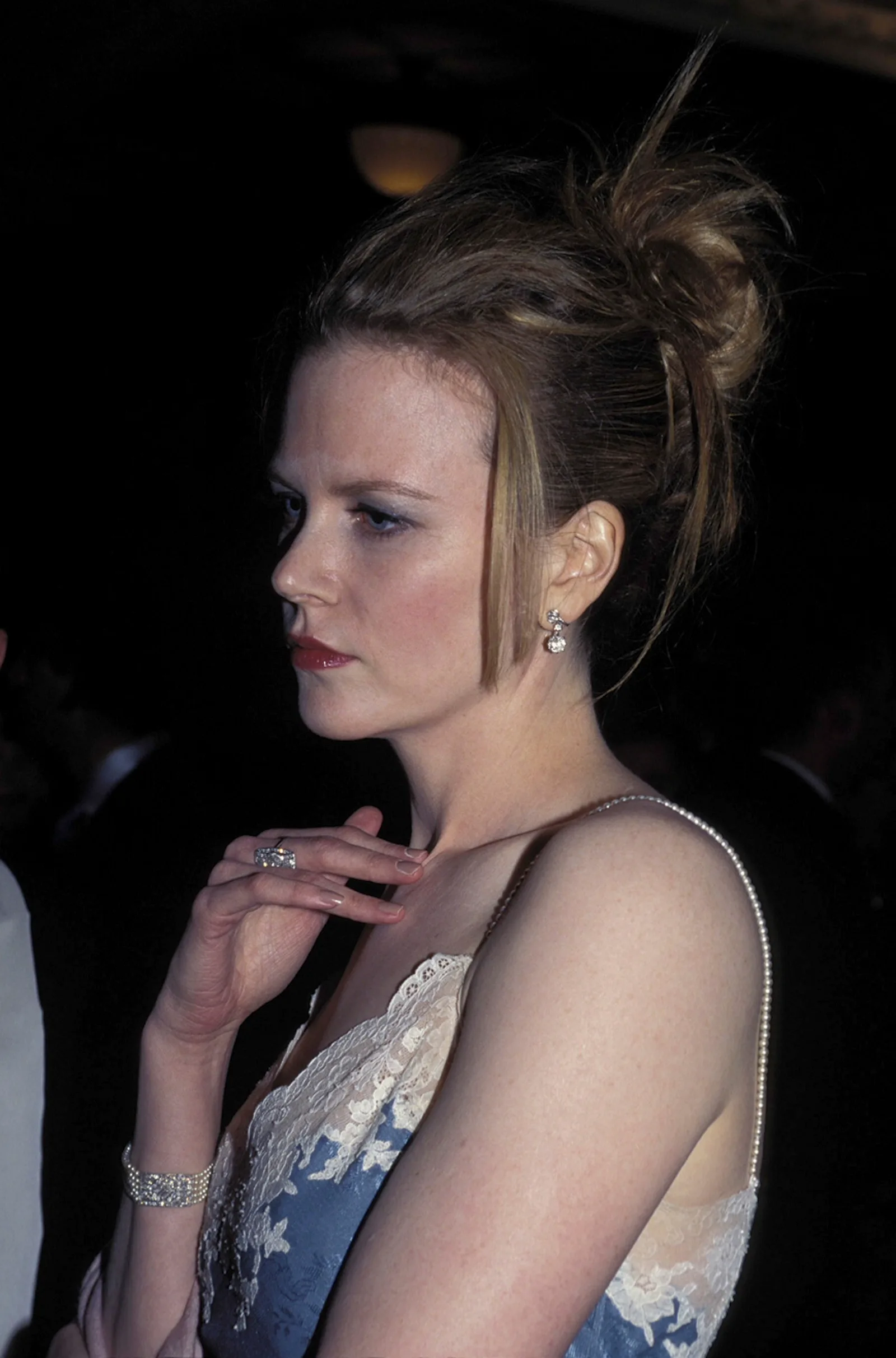 Nicole Kidman at the AFI Awards in Sydney with her hair styled in a sleek updo. The natural curls are completely smoothed out, with a few straightened strands left loose at the front, signaling a clear move away from her natural texture.