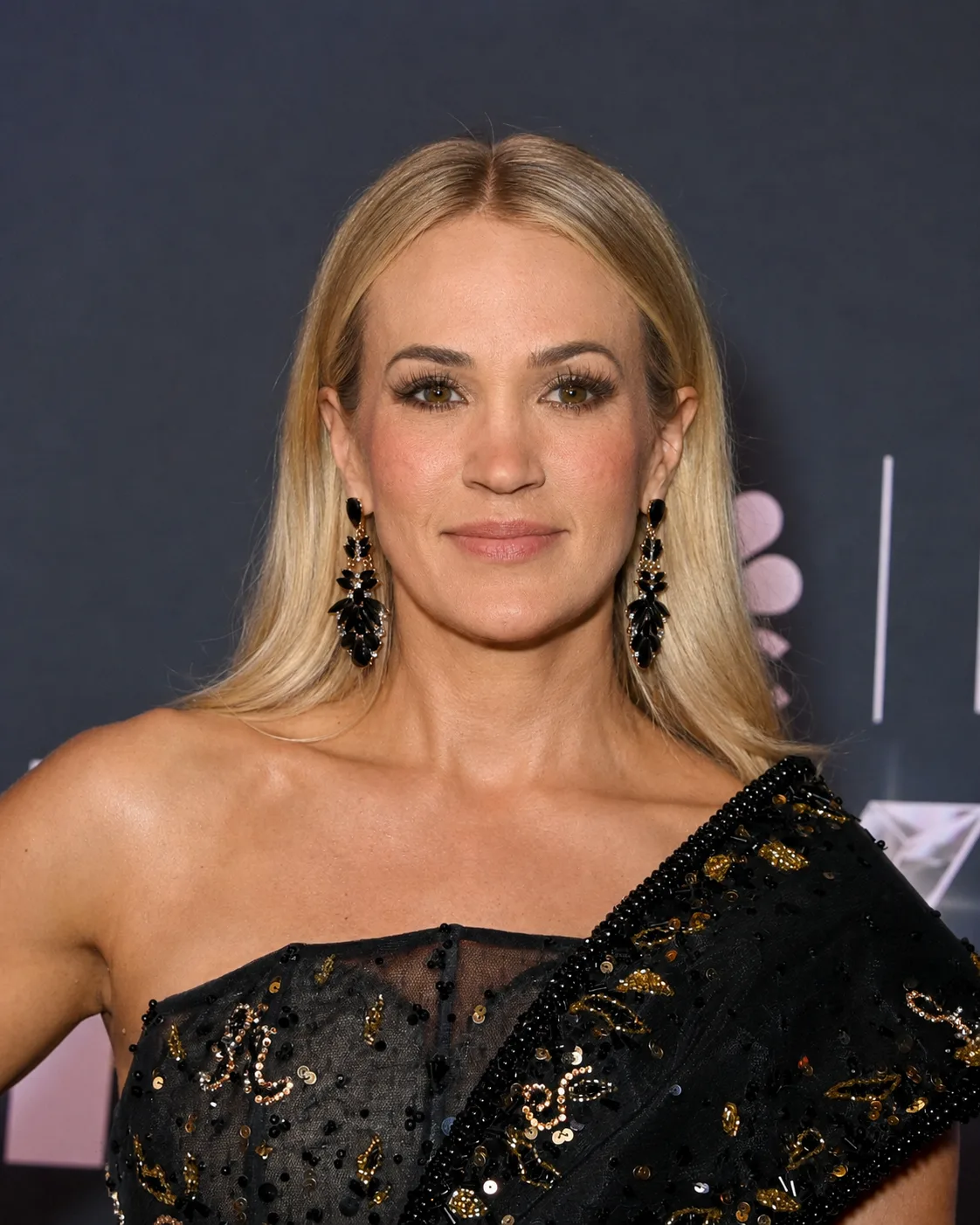 AI-generated visualization showing Carrie Underwood with straight blonde hair, understated makeup, and a natural-looking smile.