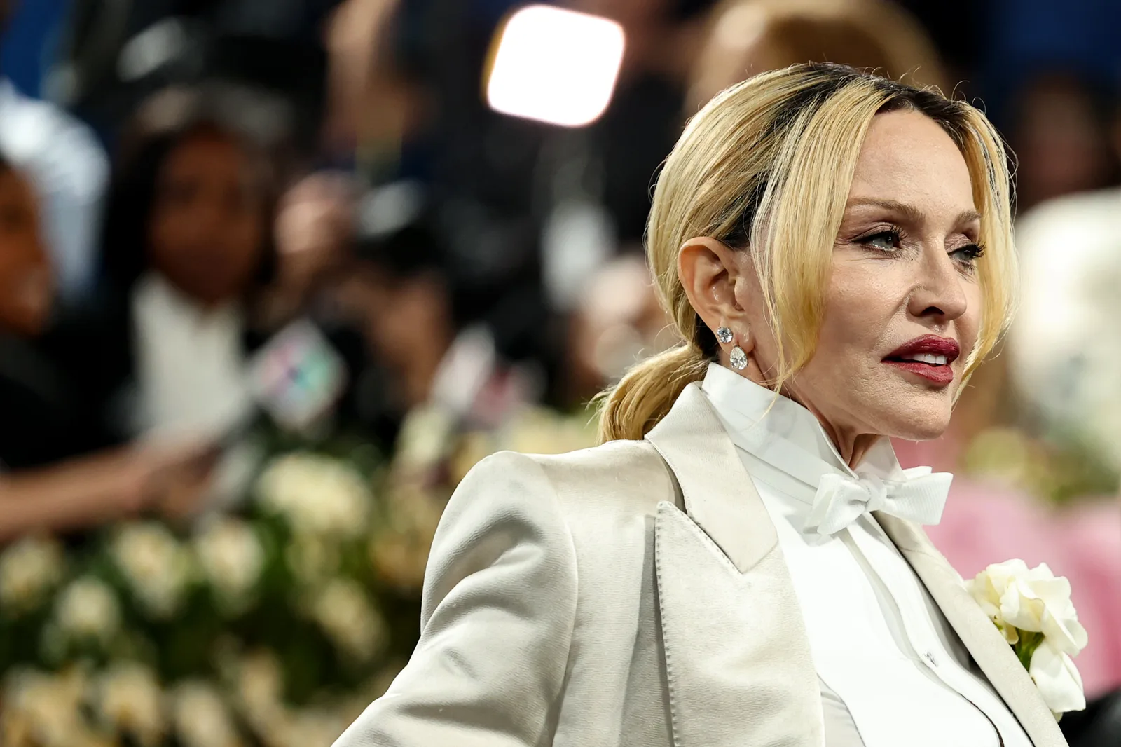 Another photograph from the 2025 Met Gala captures Madonna from the side as she moves through the event. Her blond hair was pulled into a low ponytail, with loose strands framing her face and diamond earrings completing the look.