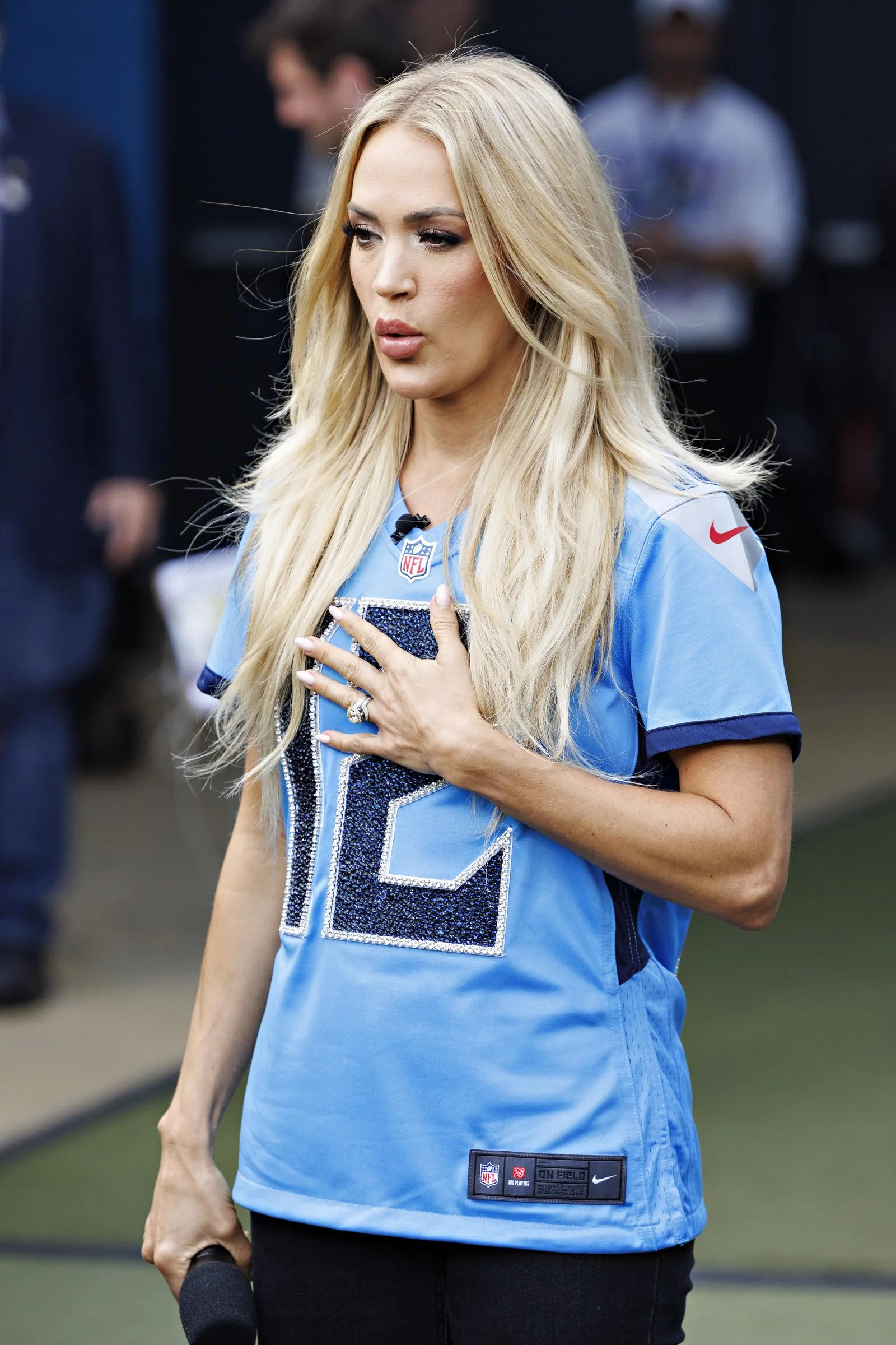 Carrie Underwood placed her hand over her heart before the Tennessee Titans' game against the New England Patriots in Nashville in November 2024. The appearance came during a year when public interest in her changing look remained high.