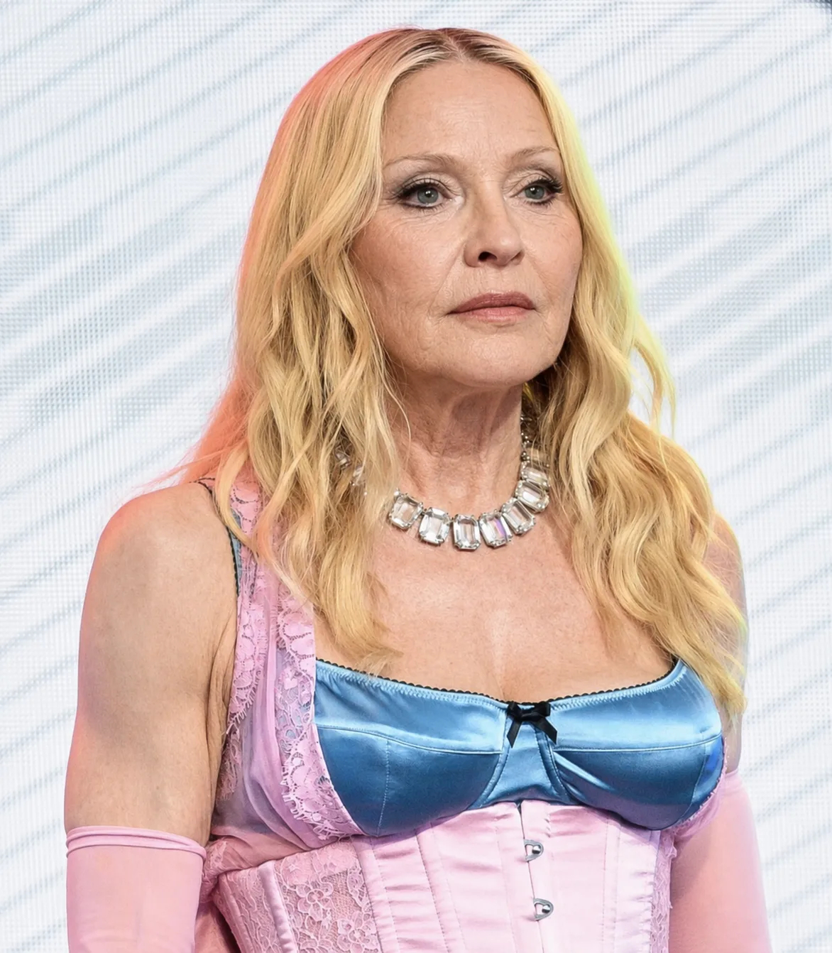 In the digitally transformed image, Madonna's colorful outfit and blond hairstyle remain while her face, neck and upper chest are presented with more visible signs of aging.