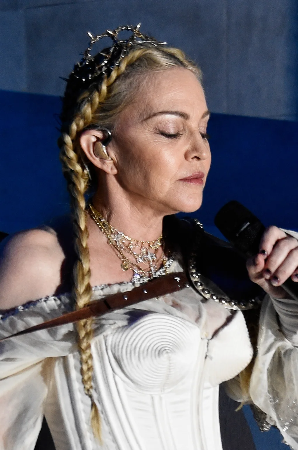 The AI interpretation maintains the stage costume, braids and microphone while presenting a reworked version of Madonna’s face and skin.