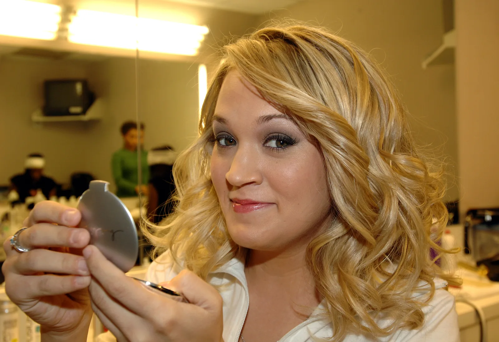 As Underwood advanced through "American Idol," her television styling became more polished with curled blonde hair and stage-ready makeup. Photos from this period are often compared with more recent appearances.