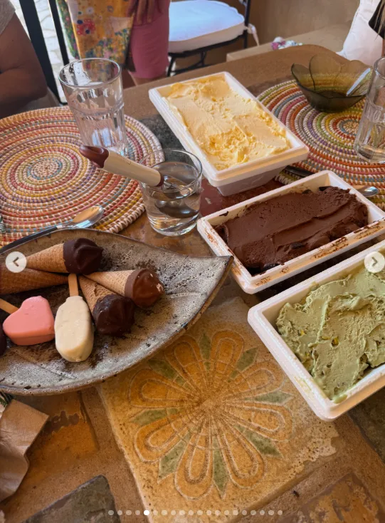 Ice cream tubs, chocolate-dipped cones and other frozen treats covered the table in another image from the trip. The food photo shows that Hudson's post documented everyday family stops as closely as it did the beach scenes.