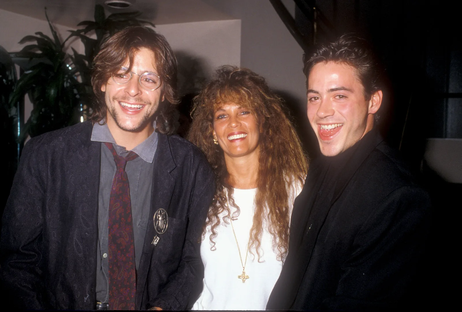 Flashing a broad smile alongside jewelry designer Loree Rodkin and a playful Robert Downey, Jr., the actor attended an Amnesty International benefit event in 1988.