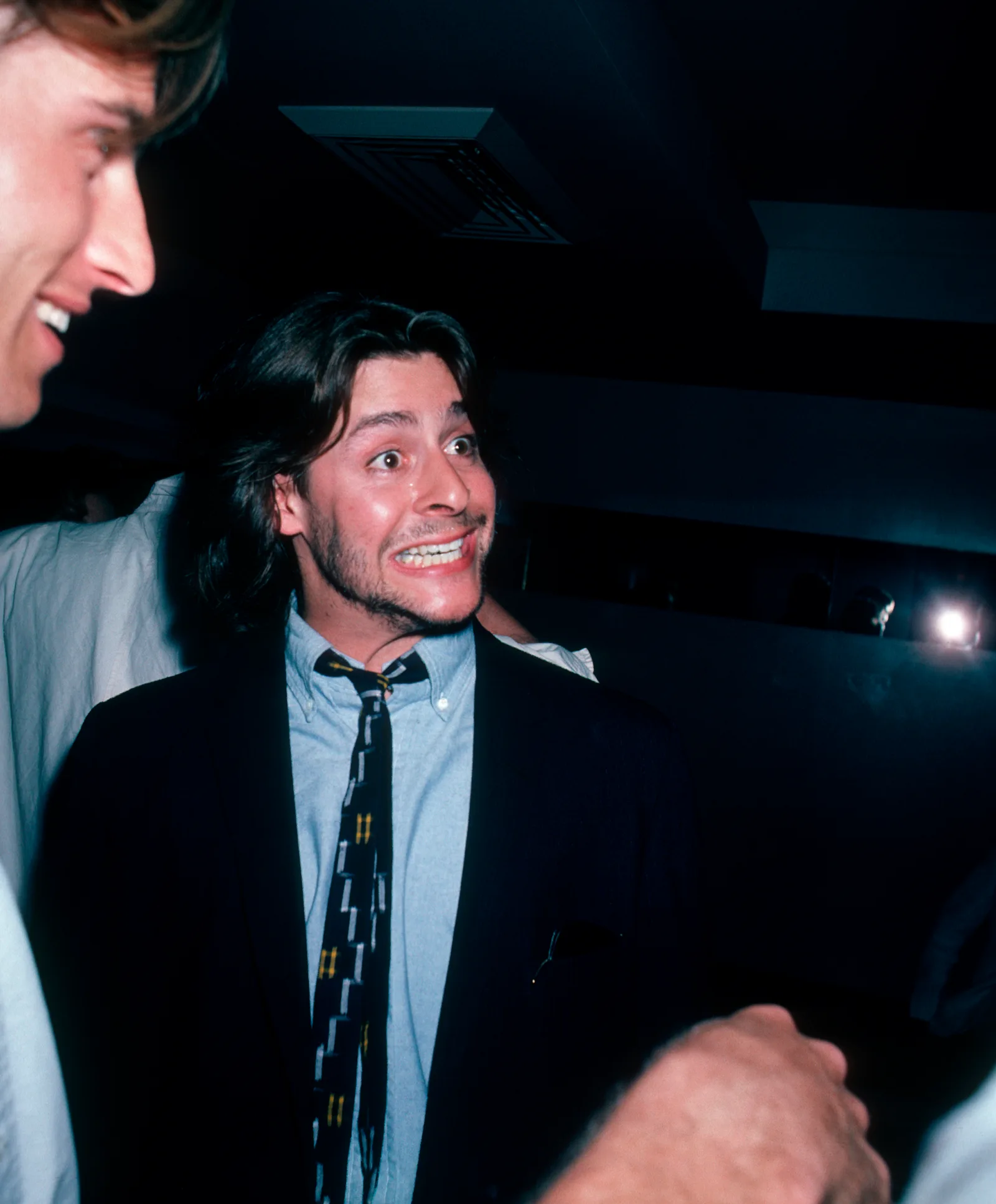 Striking an animated, wide-eyed expression during a lively conversation, the actor enjoyed a night out at the Peter Max Art Exhibit at Marylou's in New York City on May 8, 1986.