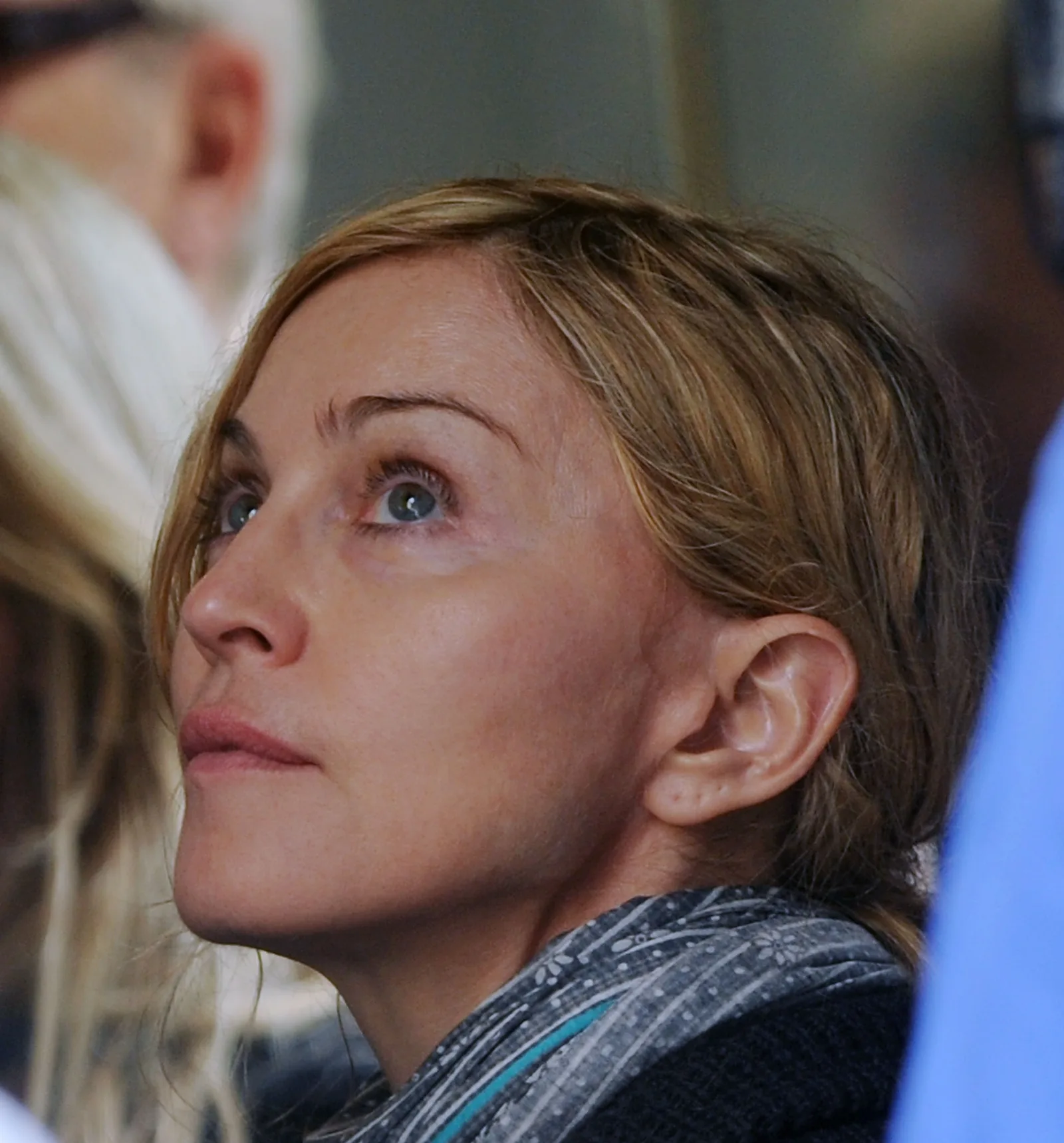 Madonna is photographed in New York City on September 13, 2010, while directing "W.E." on location in Manhattan. The candid close-up shows her looking upward while working behind the camera rather than performing for an audience.