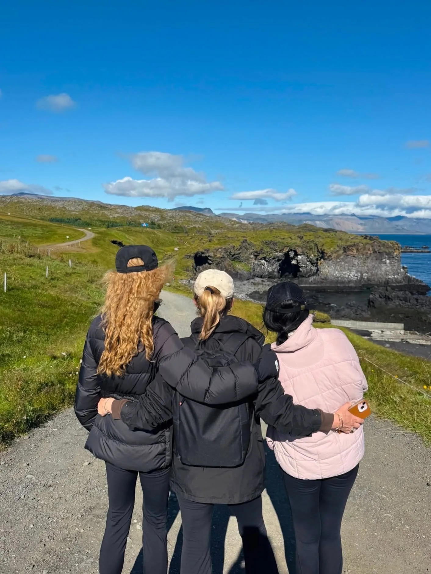 Nicole, her loved ones walk arm-in-arm while overlooking coastal paths. Bundled up in puffer coats and matching baseball caps, the trio enjoyed a scenic trek together.