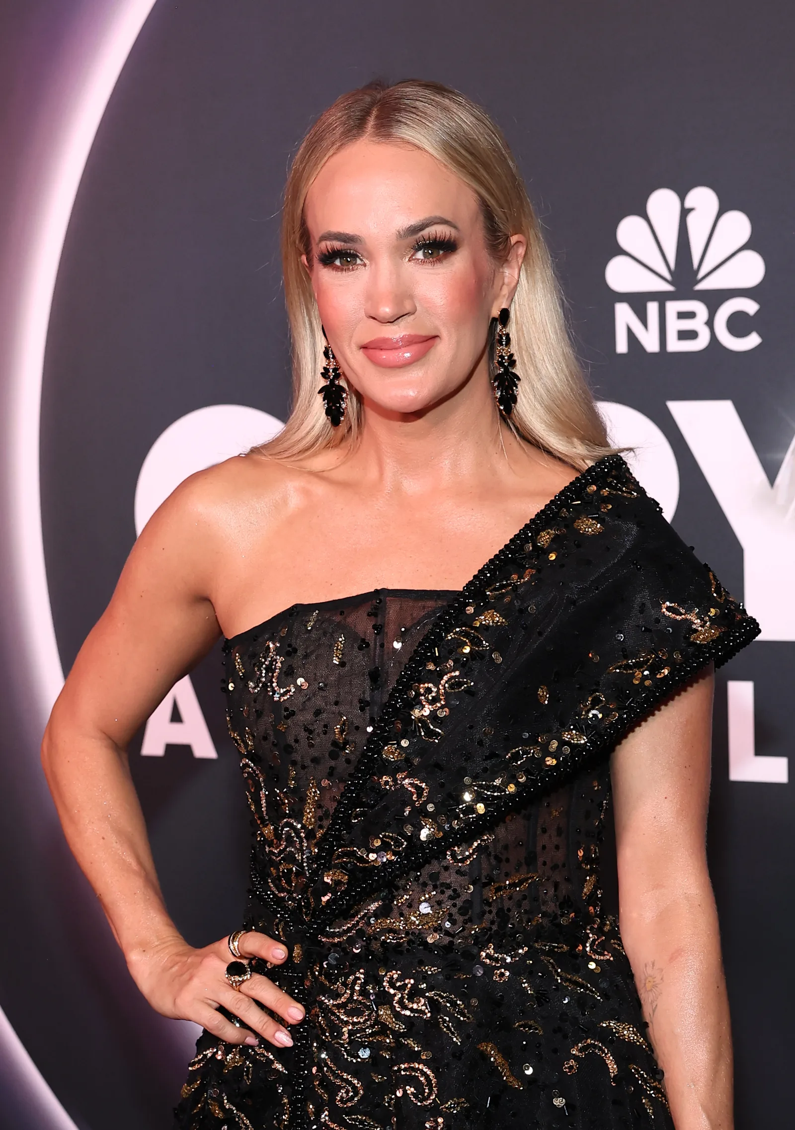 Underwood attended NBC's "Opry 100: A Live Celebration in Nashville" wearing a black one-shoulder gown with her hair styled straight and tucked behind her shoulders. The appearance came as discussions about her evolving look continued online.
