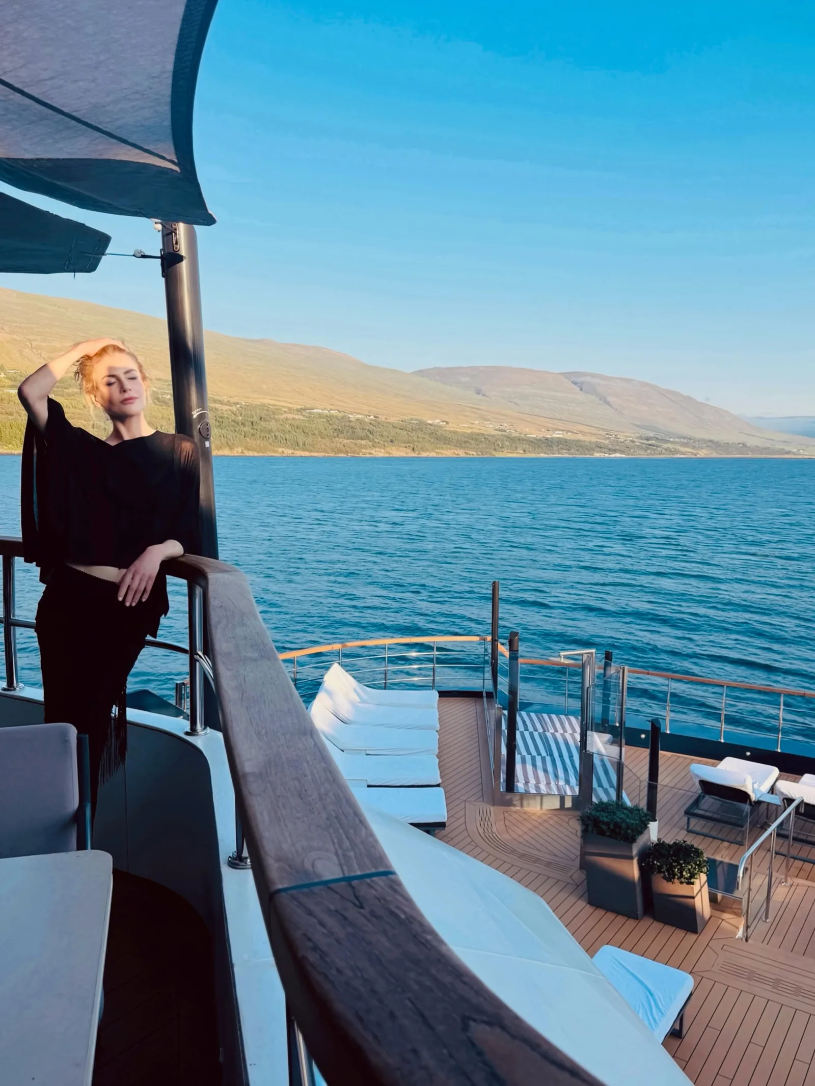 Basking in the Icelandic atmosphere, Nicole strikes a pose on an upper deck surrounded by scenic fjords. Dressed in an all-black outfit, she enjoyed high-seas views aboard the luxury vessel.