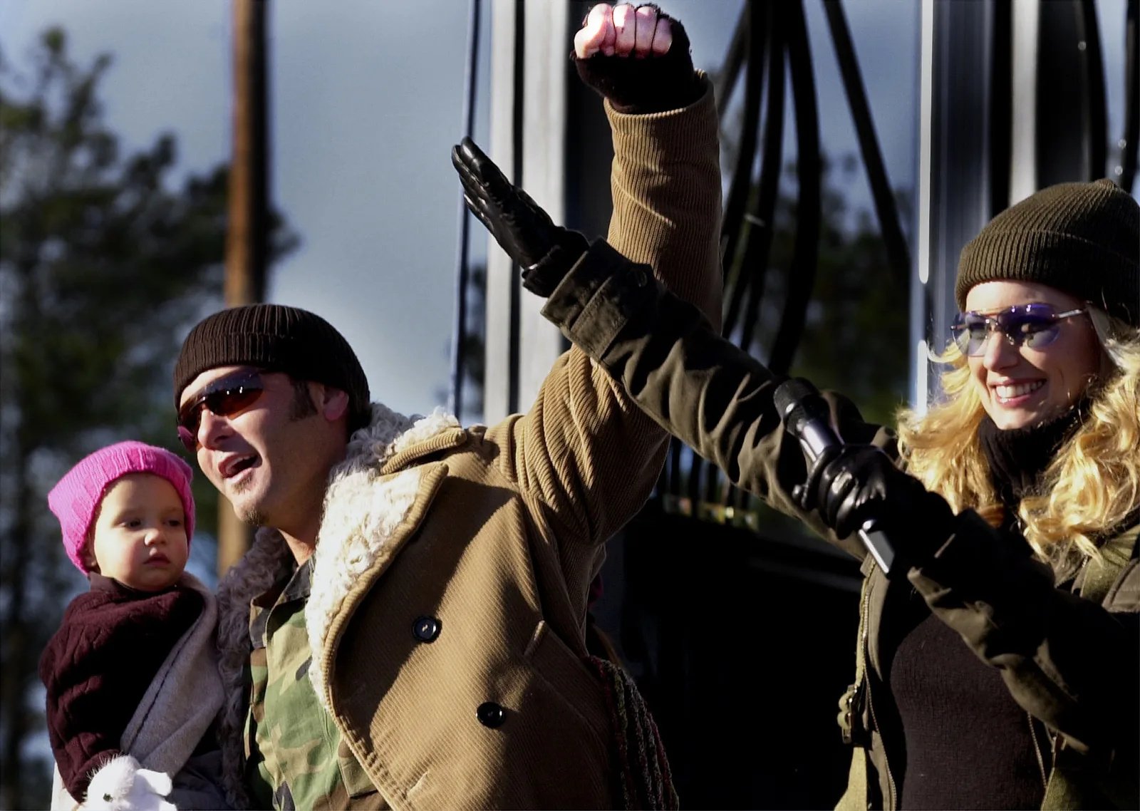 Faith Hill and Tim McGraw wave to troops with their young daughter Audrey in 2003. Years later, Audrey would follow her older sister into entertainment, pursuing acting and music while carving out a career of her own.