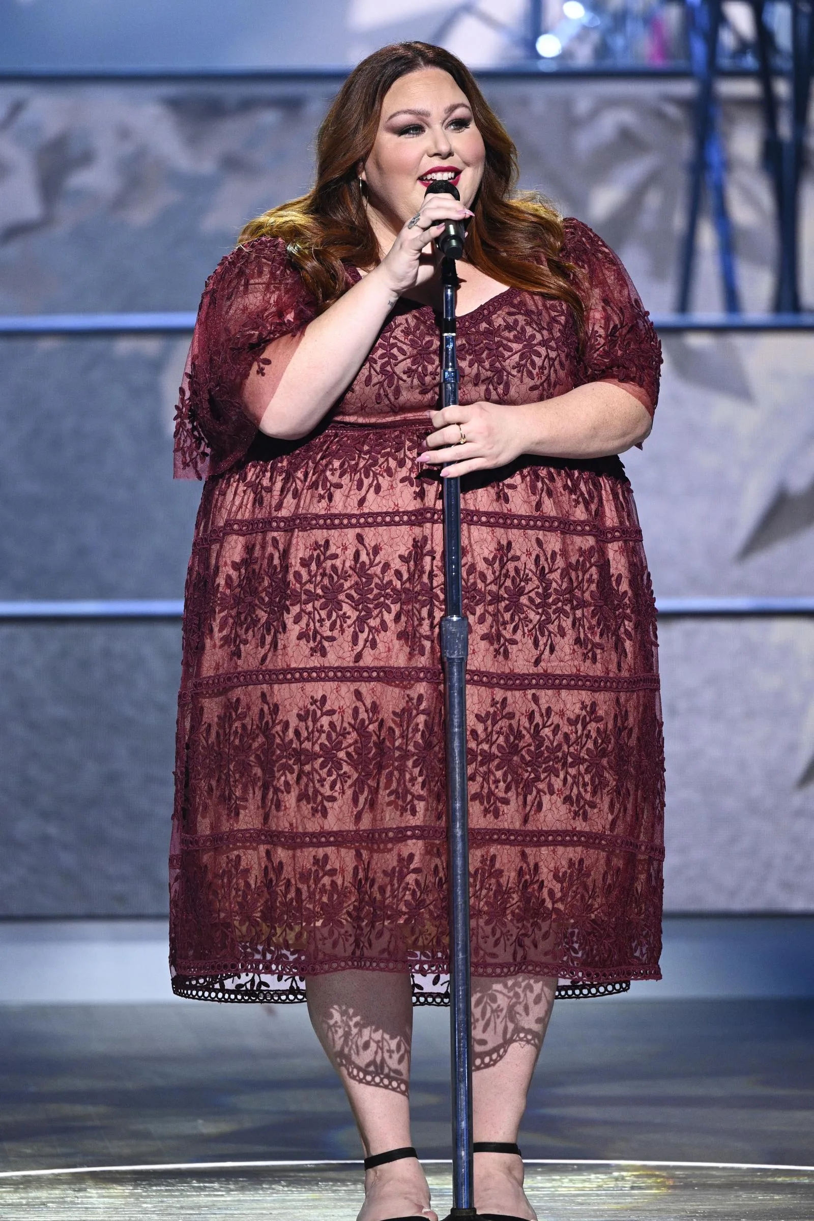 Metz performed in a burgundy lace dress during "Christmas at the Opry." The stage photo also shows her before the Broadway workload she later said became easier to manage during treatment.