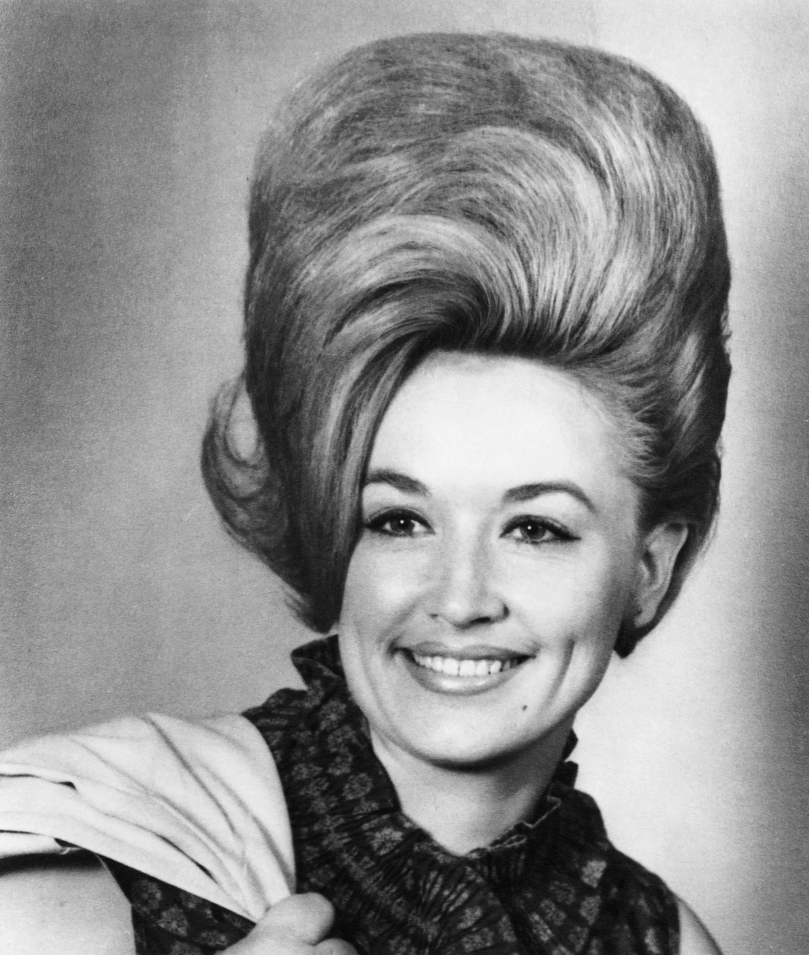 Parton left East Tennessee for Nashville the day after graduating high school in 1964, carrying ambitions that had begun years earlier on her family's porch. Her early career soon put her on a path from Appalachian poverty to national recognition.