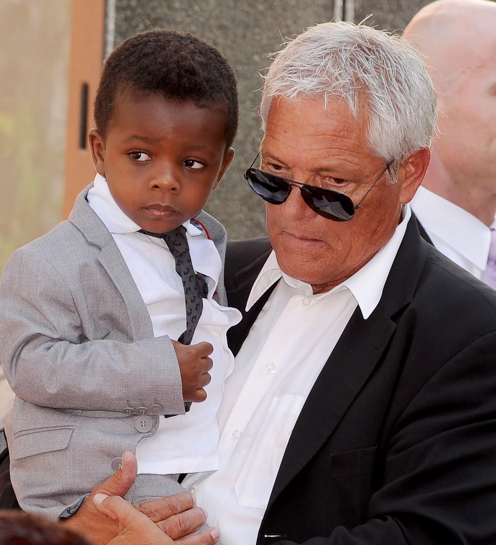 Louis Bardo as a little boy being carried by someone at his mom's Hand and Footprint Ceremony in Hollywood, California on September 25, 2013.