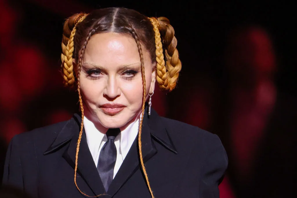 Madonna appears at the 2023 Grammy Awards in a black tailored look with her braids arranged into sculptural loops. Her appearance soon drew widespread attention.