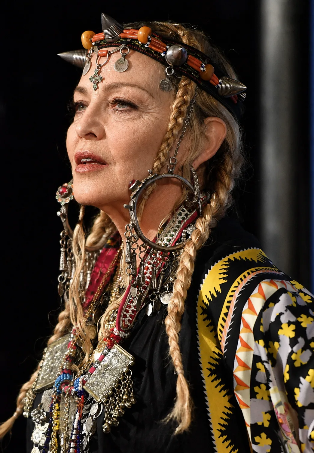 Seen through the AI treatment, the same profile and elaborate styling remain while Madonna's facial appearance takes on a different look.