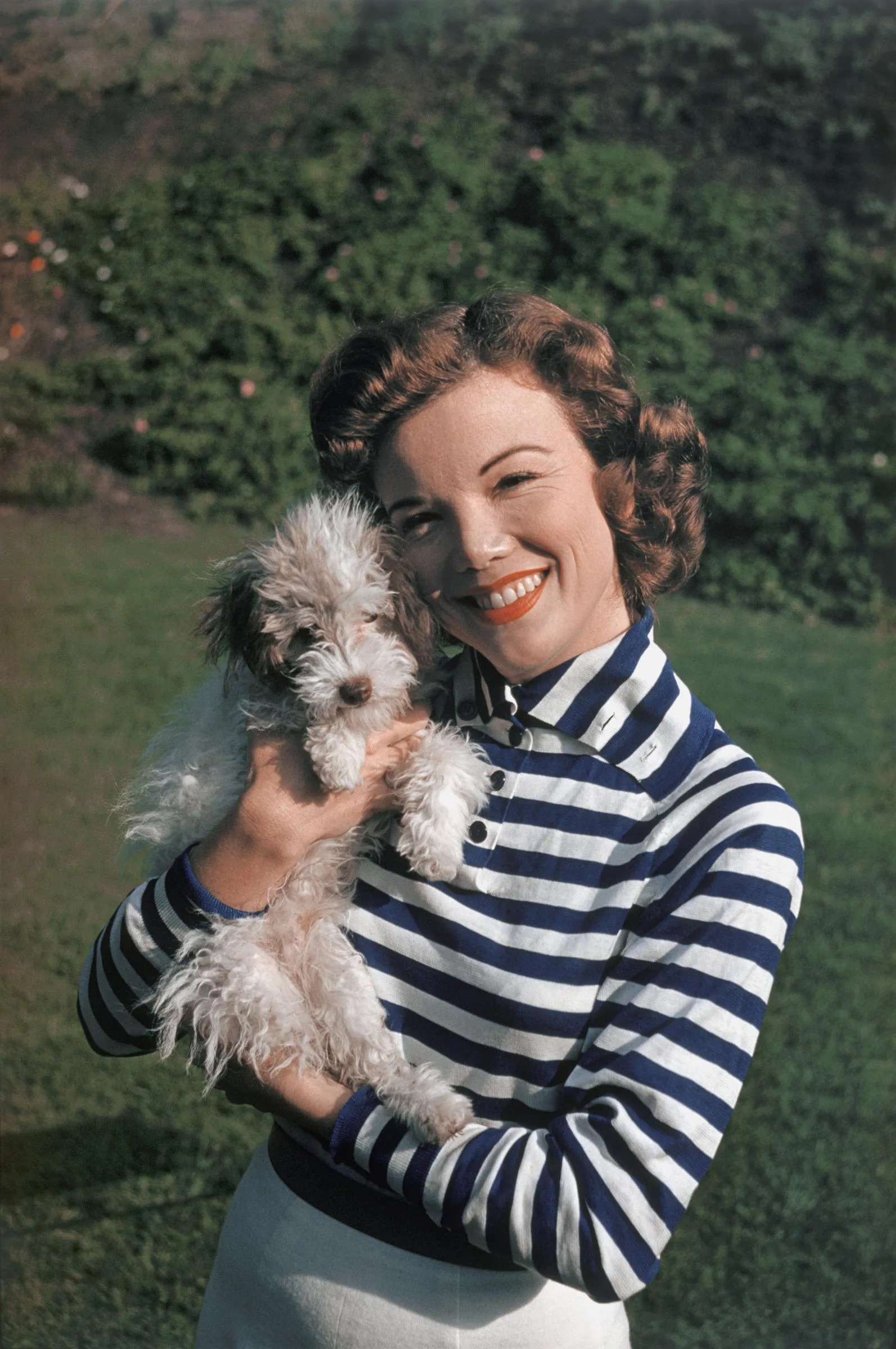 Nanette Fabray during a portrait session while playing with her dog at home circa 1959