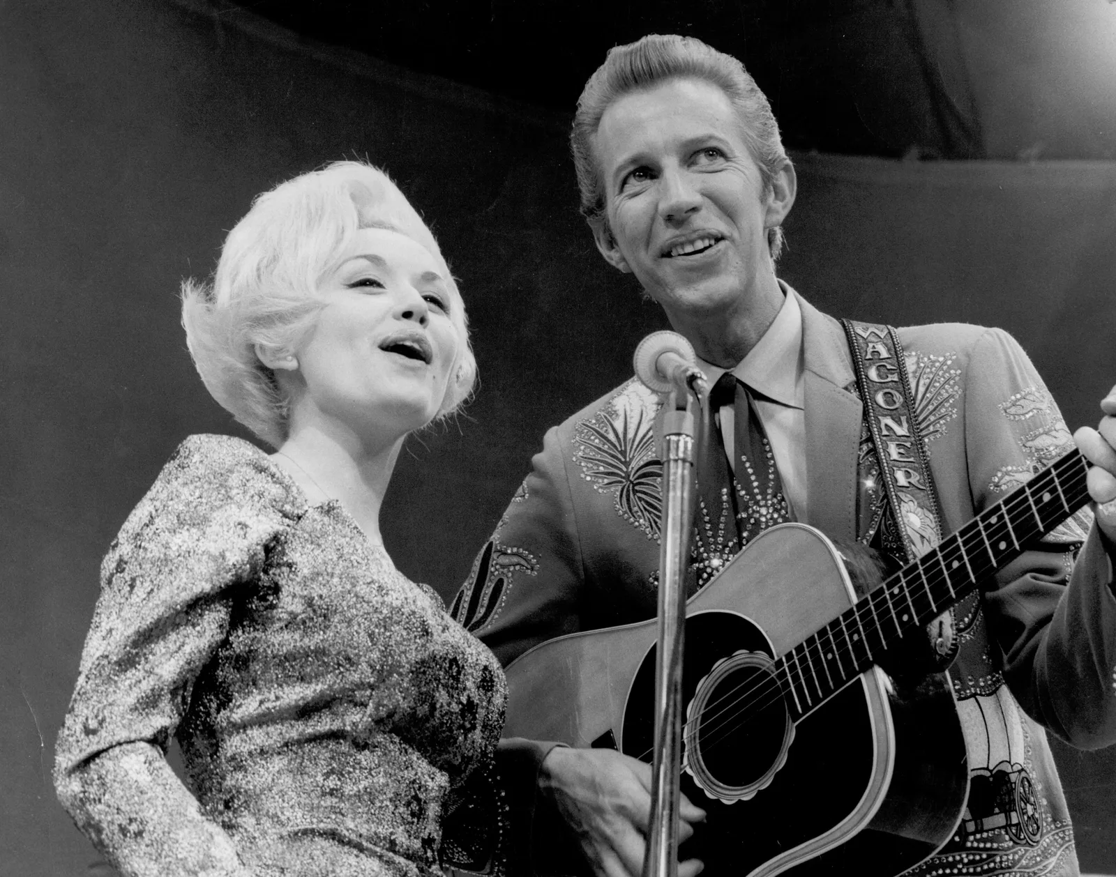 Dolly Parton and Porter Wagoner perform together circa 1967, around the time their professional partnership began on The Porter Wagoner Show and set Dolly on the path toward a solo career.