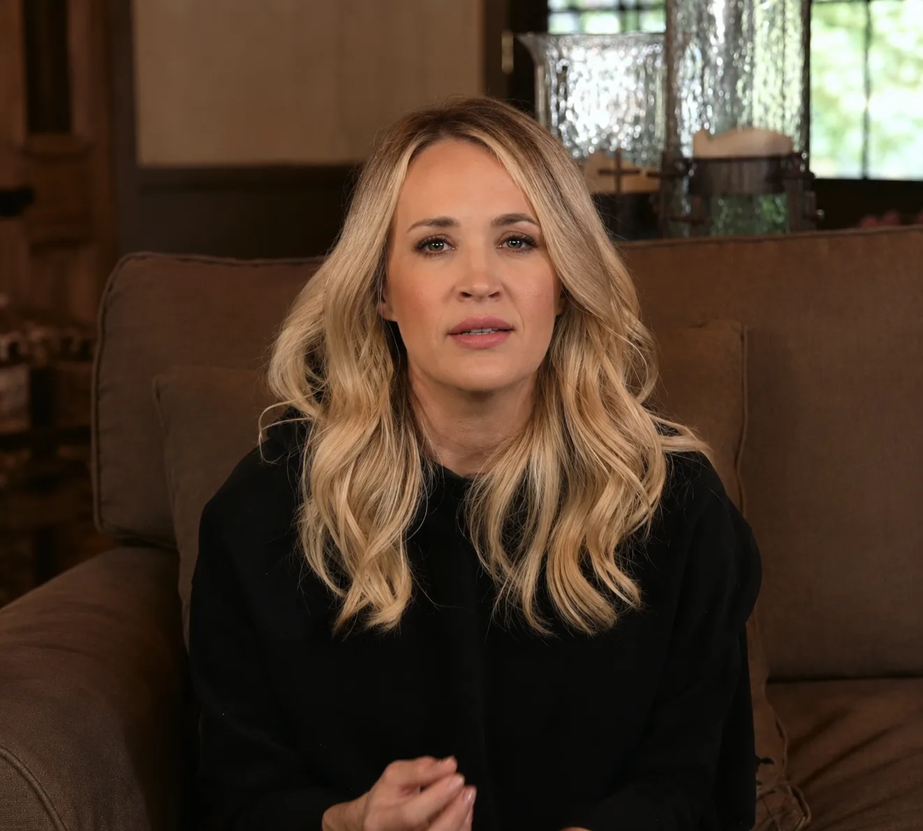 AI-generated portrait imagining Carrie Underwood with darker blonde hair, loose waves, and natural-looking makeup.