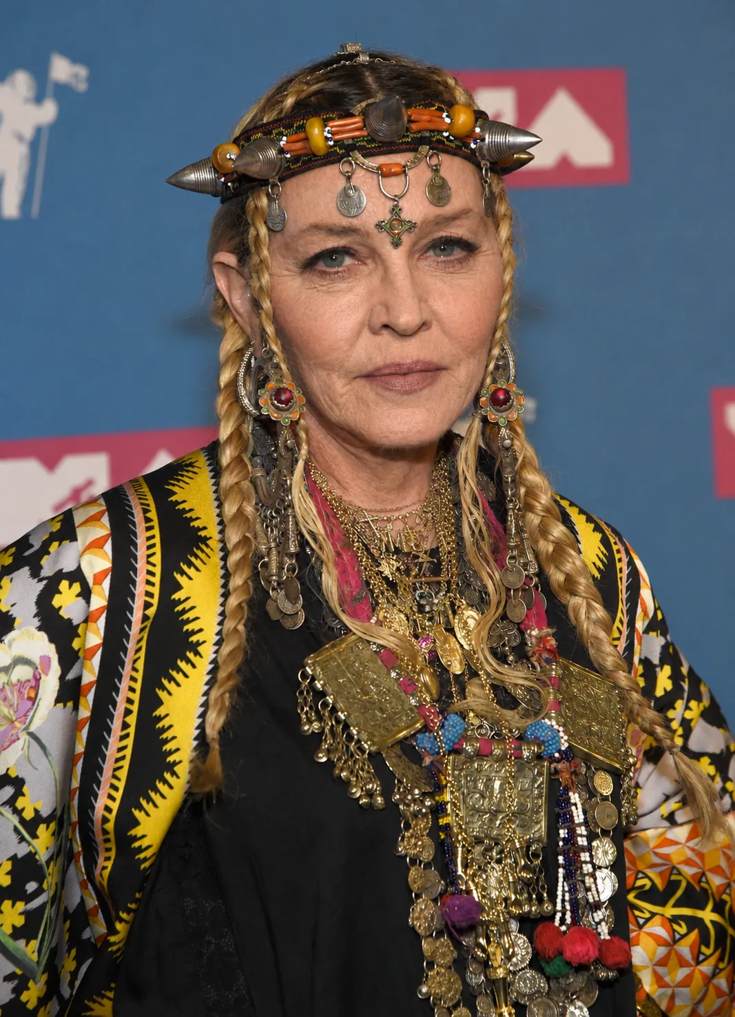 For the digital reimagining, Madonna's elaborate headpiece, braids, jewelry and patterned clothing are preserved as her facial appearance is transformed.