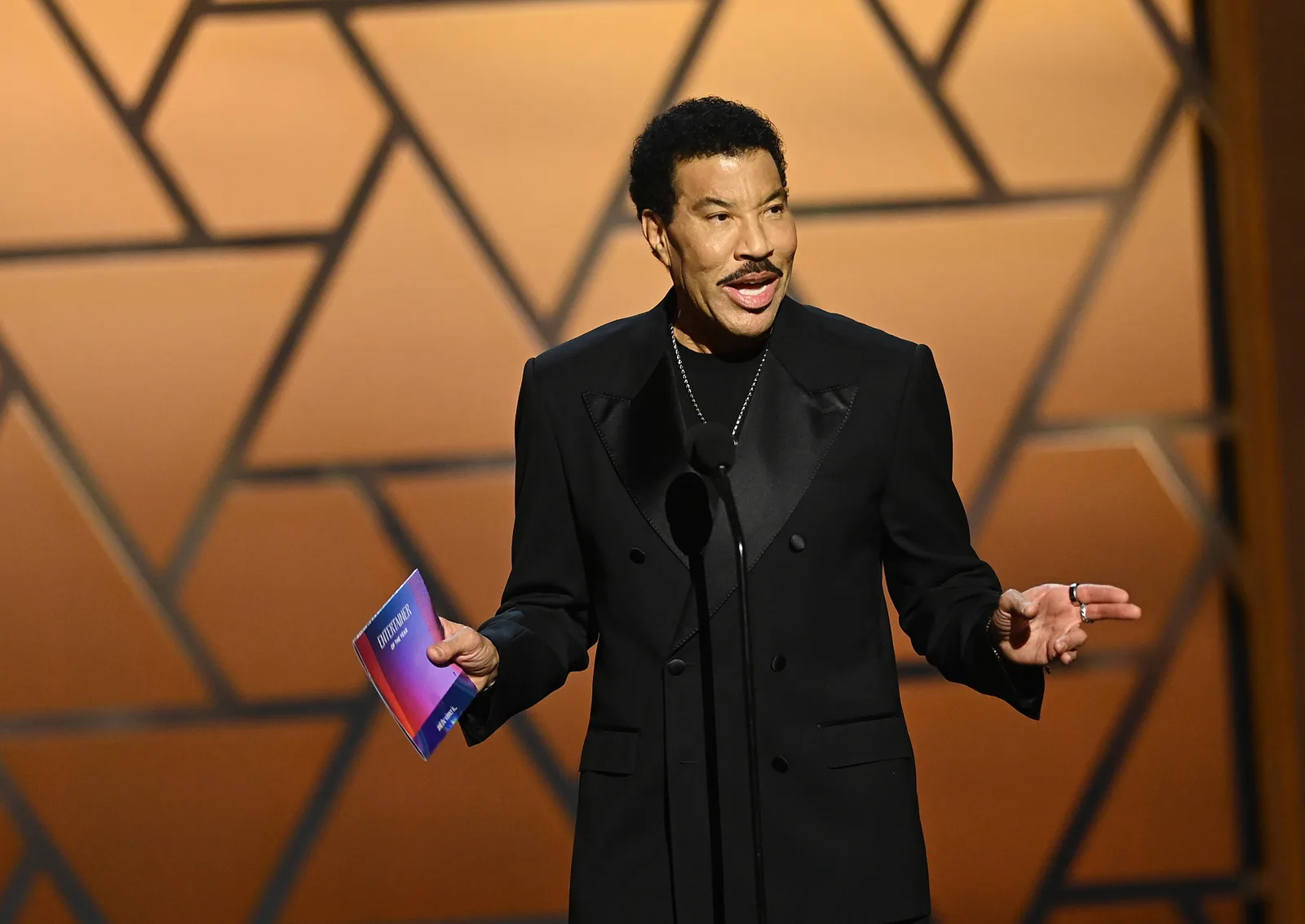 Richie speaks onstage at the NAACP Image Awards in February 2026, months before his first reported health scare of the summer. In June, a concert in St. Paul ended early after he became ill and was taken to a hospital as a precaution.