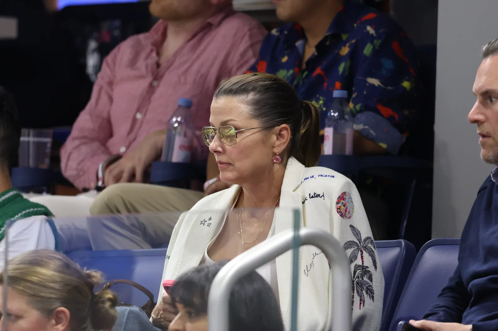 Bridget Moynahan watches the action from the stands during the 2026 US Open on August 30, 2026, in New York City, wearing sunglasses and her hair pulled back as she follows the match.