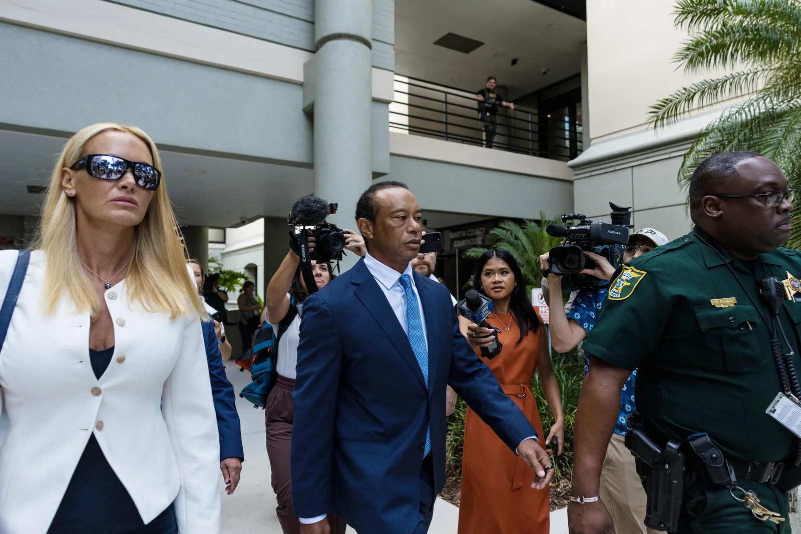 The couple's tense courthouse exit became a visual focal point, with Woods projecting a determined, tightly controlled demeanor as Vanessa Trump walked alongside him without any visible gesture of affection.